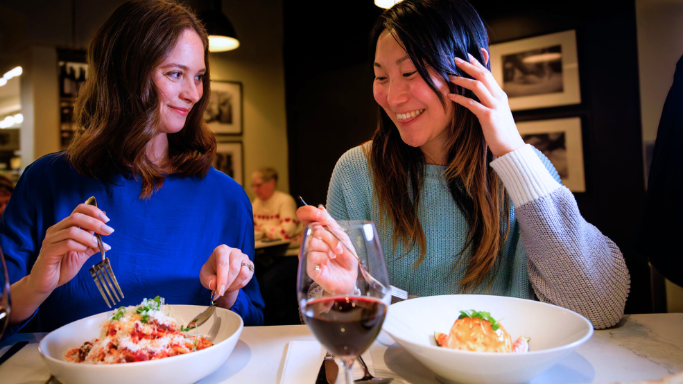 Two women eating at an Italian restaurant