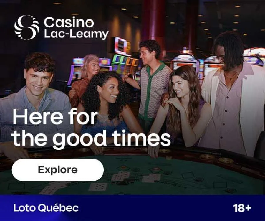 Diverse group of friends having fun around a gaming table at Casino Lac-Leamy, sharing smiles and enjoying the energetic atmosphere with slot machines behind them.
