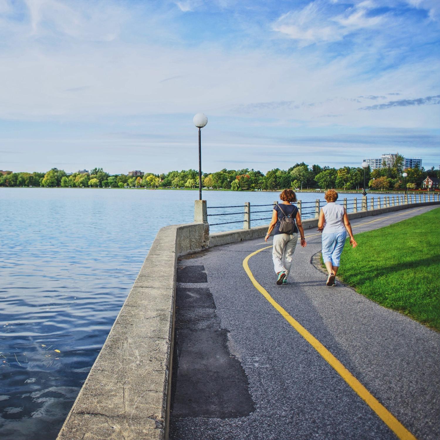 Two people walking along the Rideau Canal