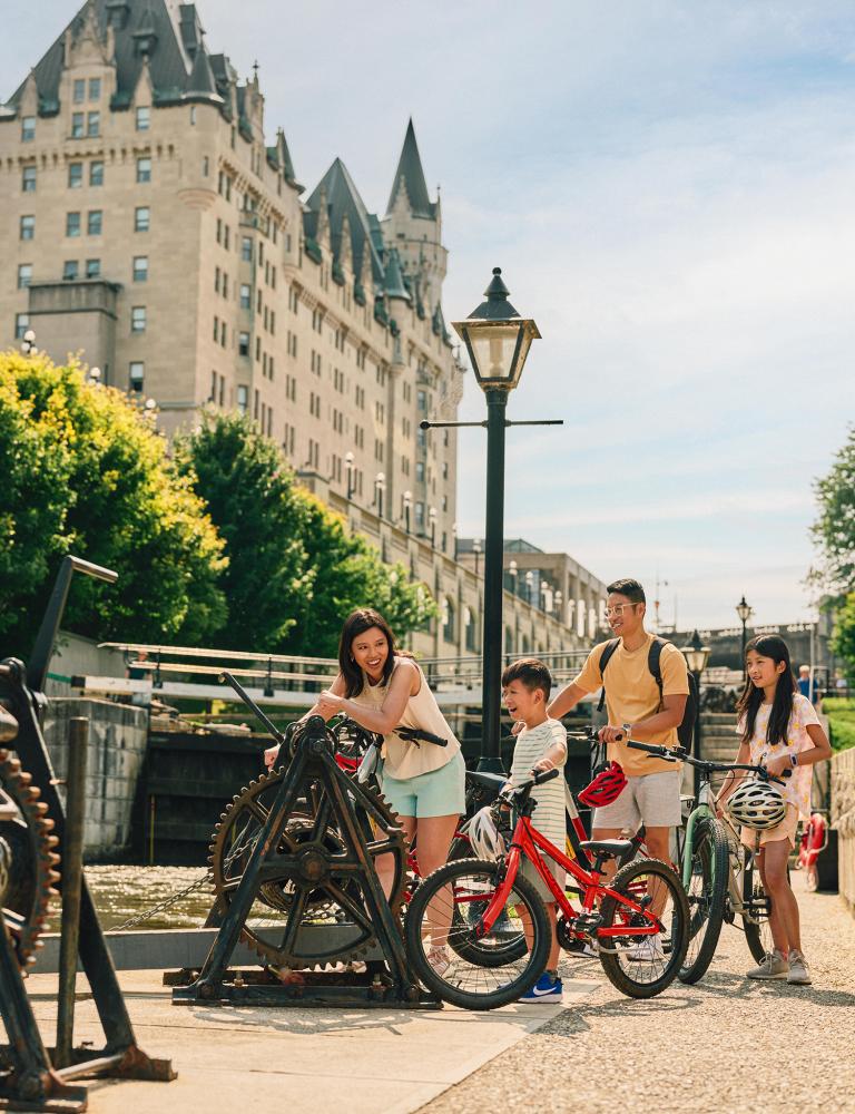 Family cycling at the Rideau Canal Locks in summer
