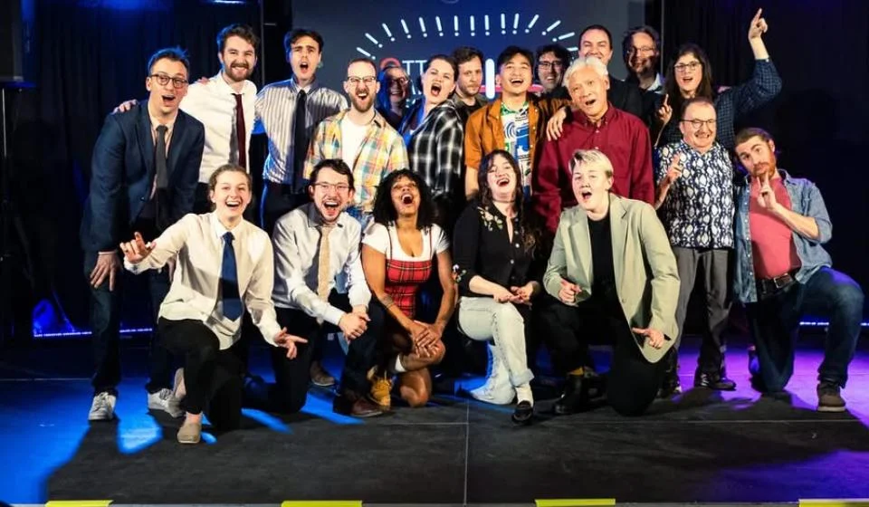 Audience of people laughing.