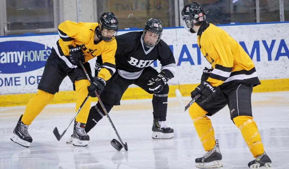 3 blind hockey players battle for the cup during the BHL series