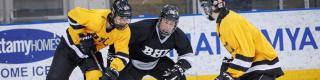 3 blind hockey players battle for the cup during the BHL series