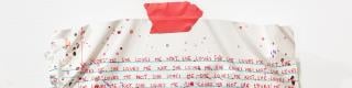 sculptural artwork of a partially crumpled piece of paper with writing on it / Œuvre d’art en relief représentant une feuille de papier partiellement froissée sur laquelle des mots ont été écrits