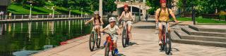 Family cycling on the Rideau Canal in downtown