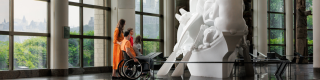 A family (including one wheelchair user) look at a sculpture at the Canadian Museum of History in Ottawa, Canada.